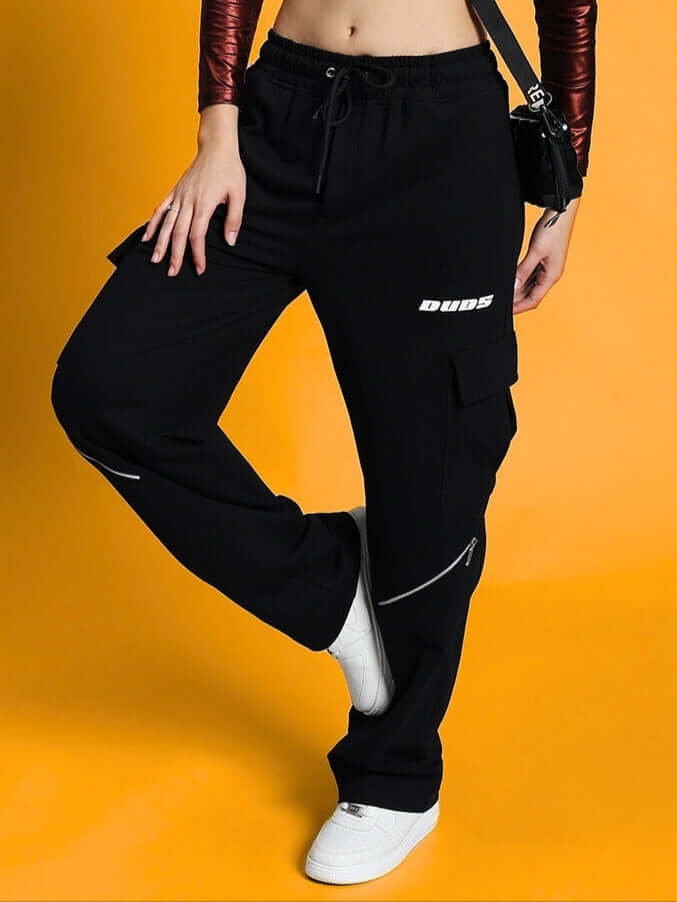 Women's Bruno 5 Pocket Cargo Pant Black featuring classic cargo style and feminine tailoring, showcased on a model against a vibrant background.