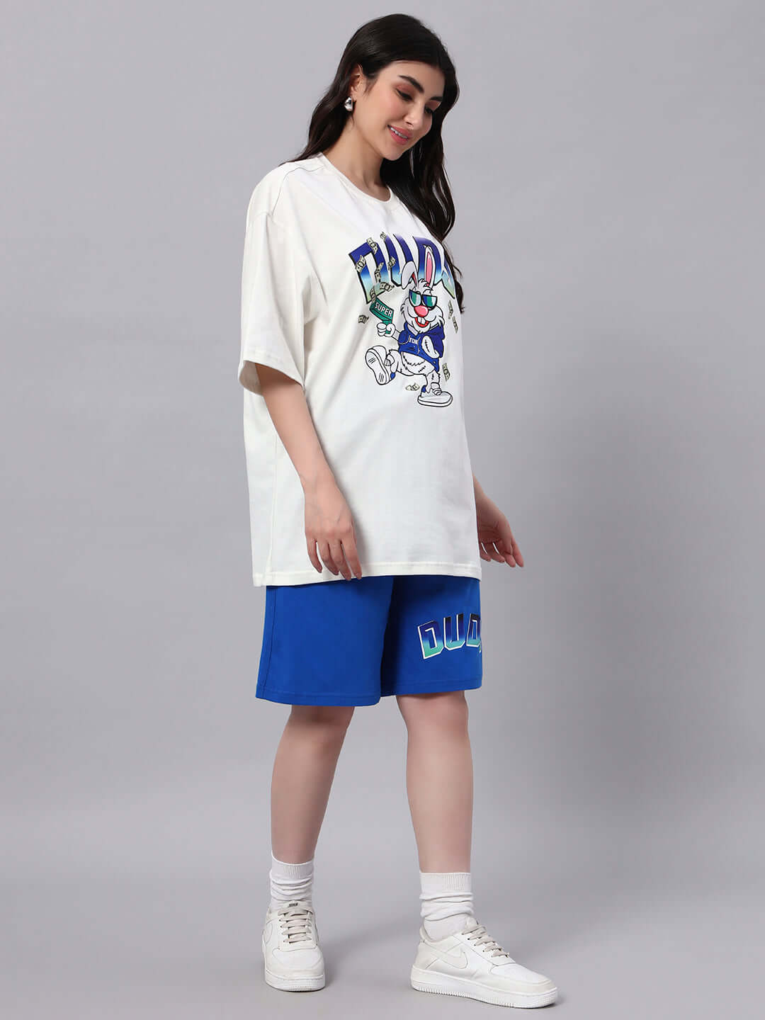 Woman wearing off-white and blue Bunny Bugs co-ord set made from premium cotton fabric, featuring cartoon graphic print.