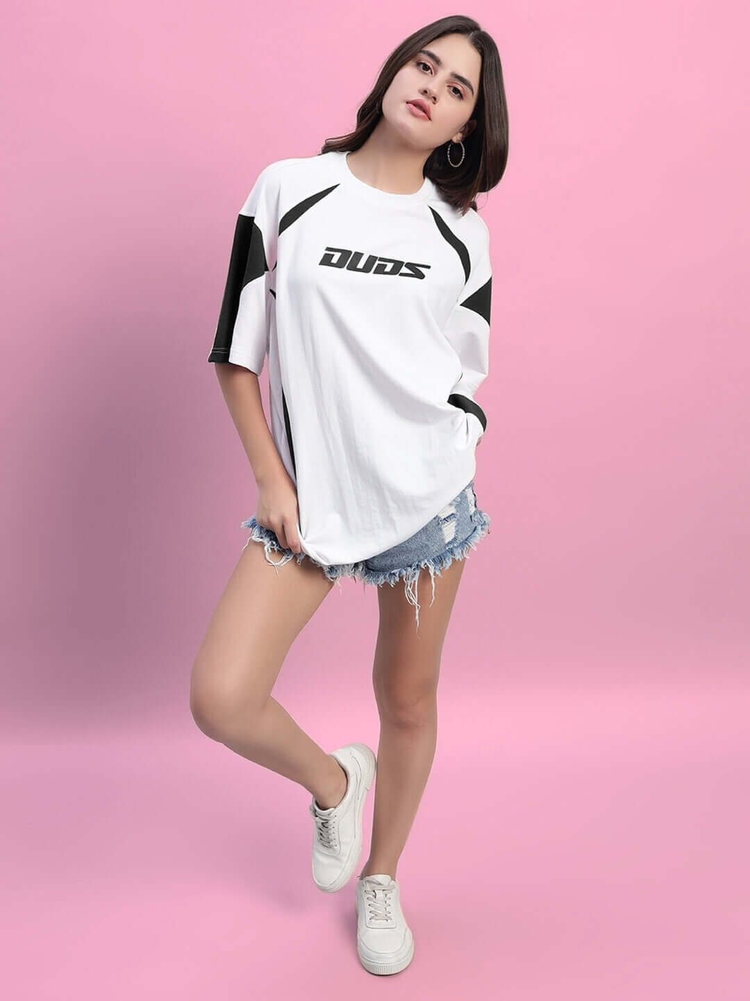 Model wearing Women's Candor oversized T-shirt in white black, made of premium cotton French terry with elastane, styled with denim shorts.