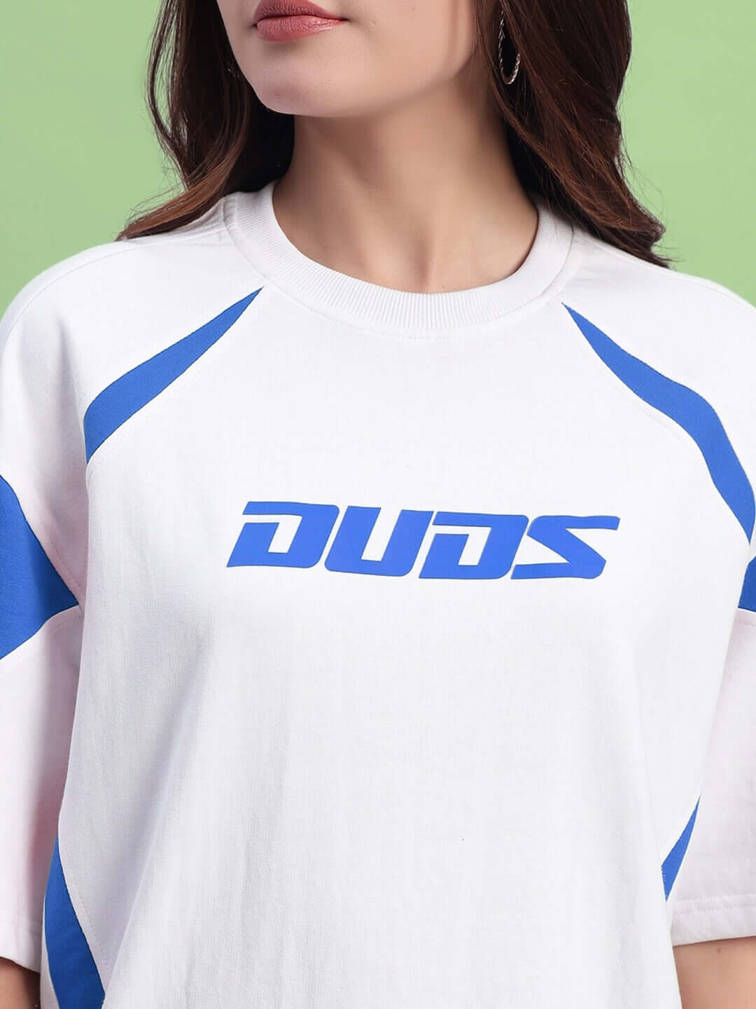 Close-up view of a women's oversized white and blue T-shirt made from premium cotton French terry fabric with blue logo design.
