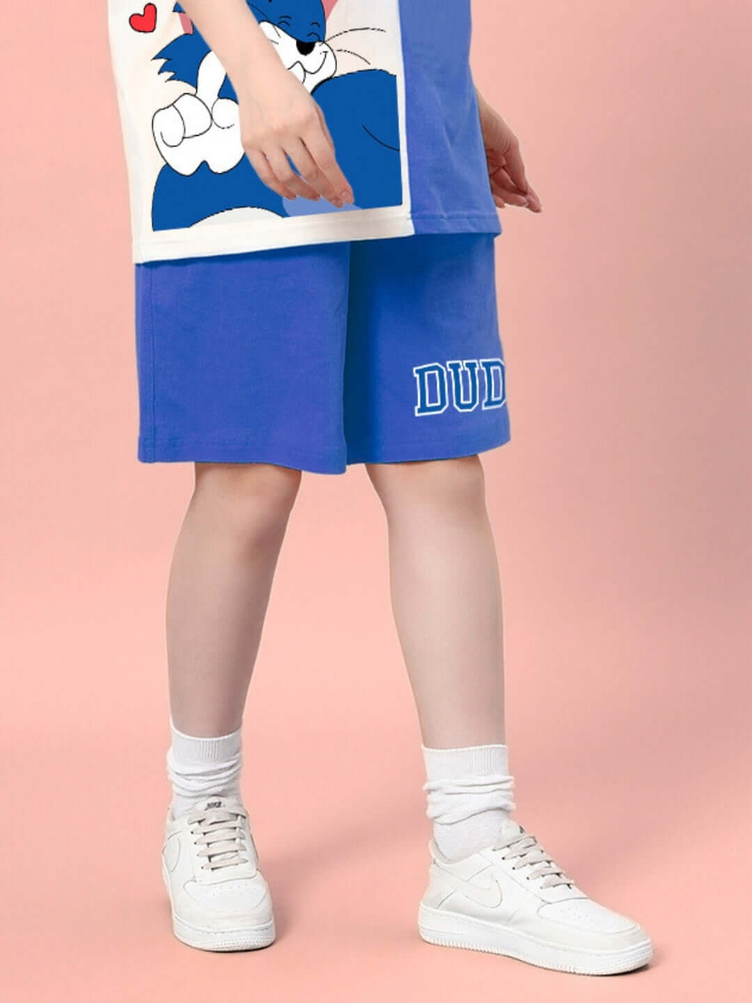 Women's blue Caper Tom summer shorts by DUDS paired with white sneakers, showcasing a casual outfit option for customization in size.
