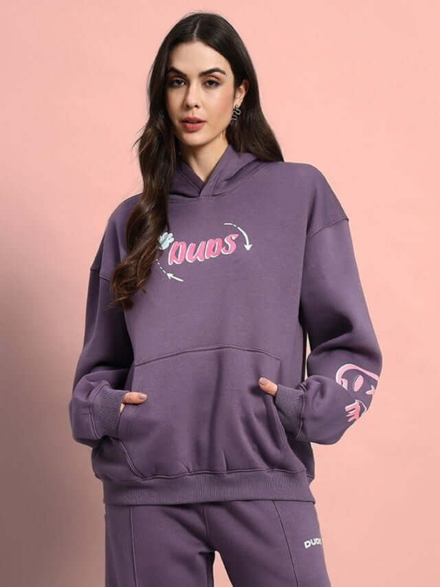 Woman wearing Women Casper Oversized Fleece Hoodie Violet with graphic print, showcasing fashion-forward streetwear style and comfort.
