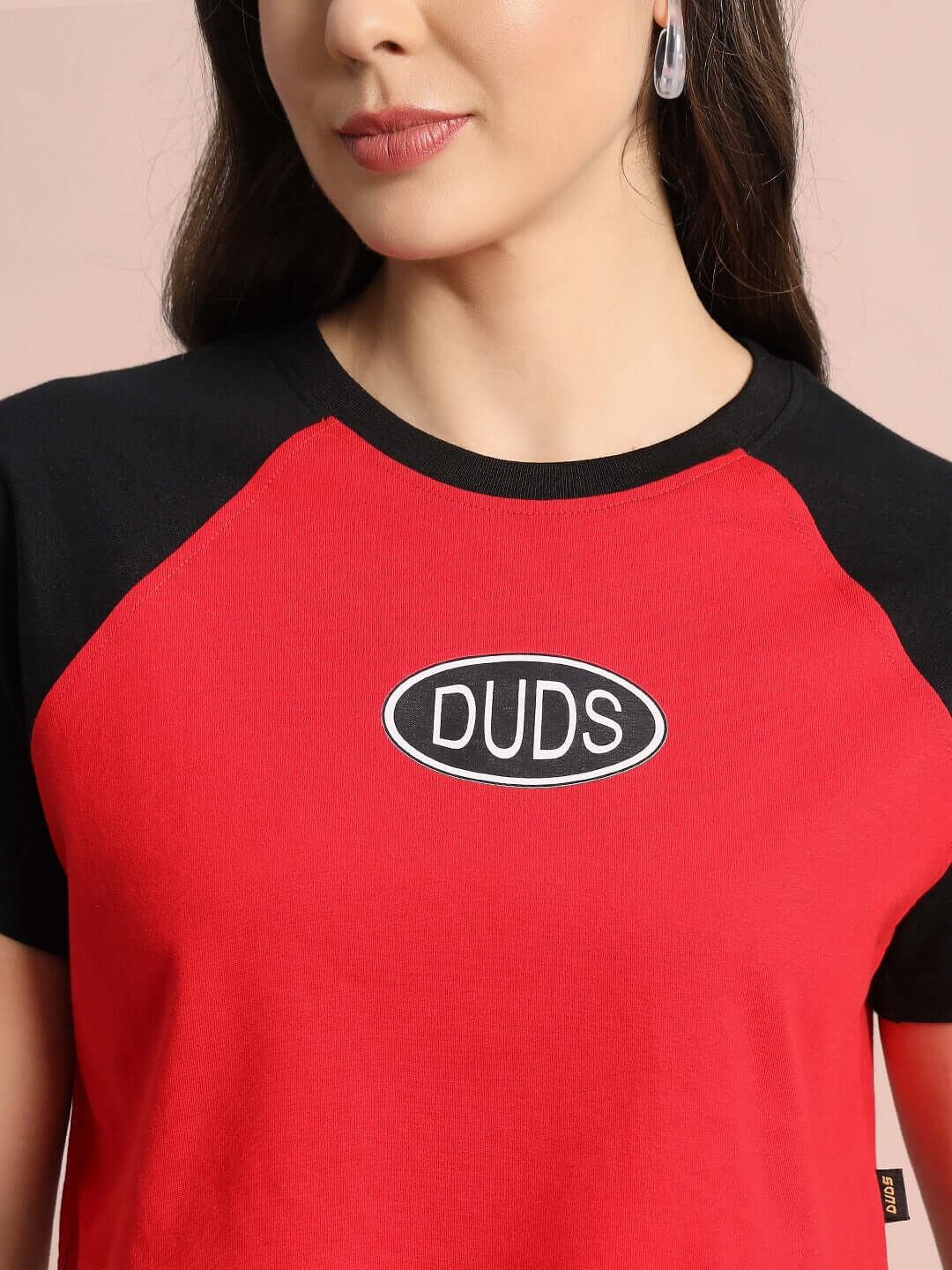 Women's red and black raglan crop-top with 'DUDS' logo, made from premium cotton fabric, showcasing stylish casual wear for women.