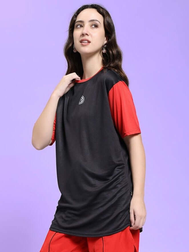 Woman wearing WOMEN CHAMPION ZONE REGULAR FIT T-SHIRT BLACK RED, showcasing sporty and stylish design against purple background.