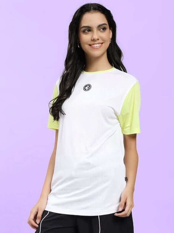Woman wearing WOMEN CHAMPION ZONE REGULAR FIT T-SHIRT WHITE NEON-GREEN showcasing sporty streetwear style.