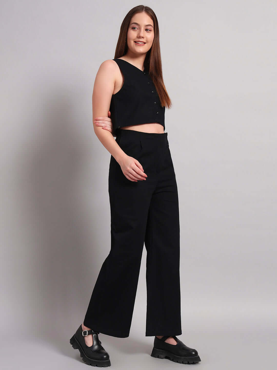 Woman wearing a chic black co-ord set made of premium 100% cotton twill fabric, ideal for stylish and comfortable wear.