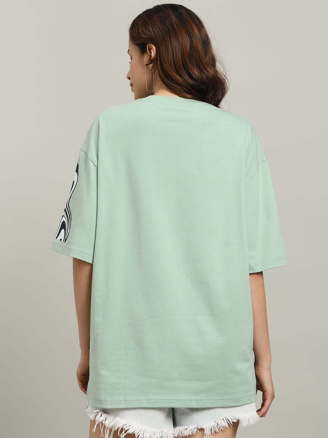 Back view of women's oversized Chimera T-shirt in Nyanza Green, featuring premium cotton French terry material for comfort and style.