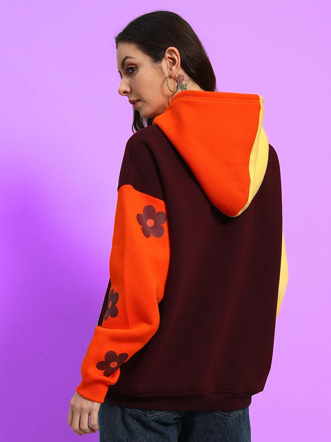 Women's Cosmos oversized fleece hoodie in multi colors, featuring floral designs on sleeves, perfect for cozy, stylish wear.