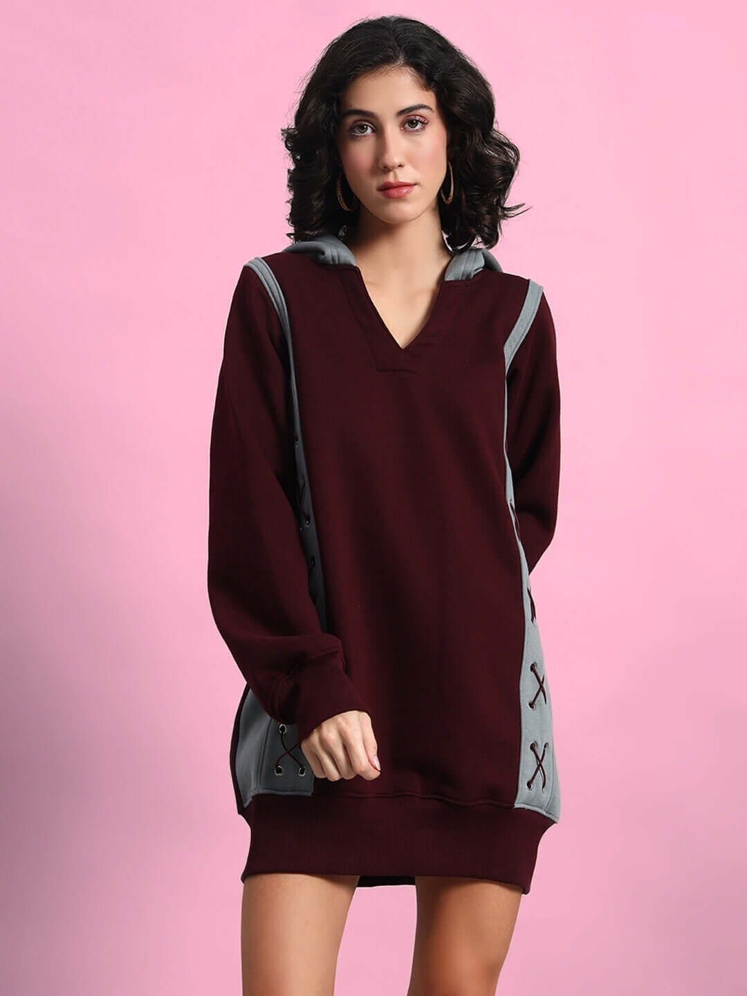 Model wearing WOMEN CRISS CROSS FLEECE HOODIE WINE GREY against a pink background.
