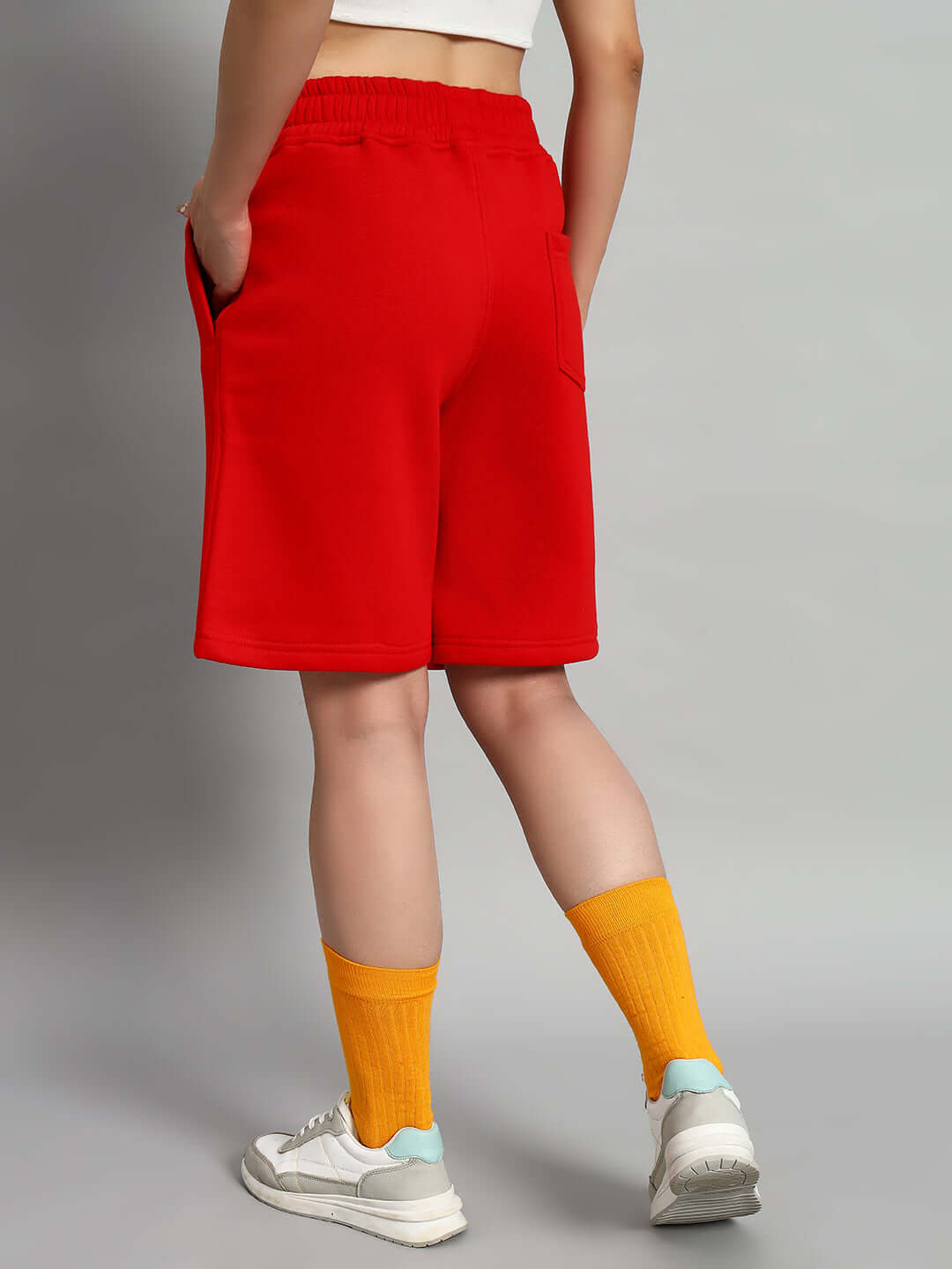Back view of WOMEN CUPCAKE FLEECE SHORTS RED with pockets, highlighting comfort fit and vibrant color in streetwear style.
