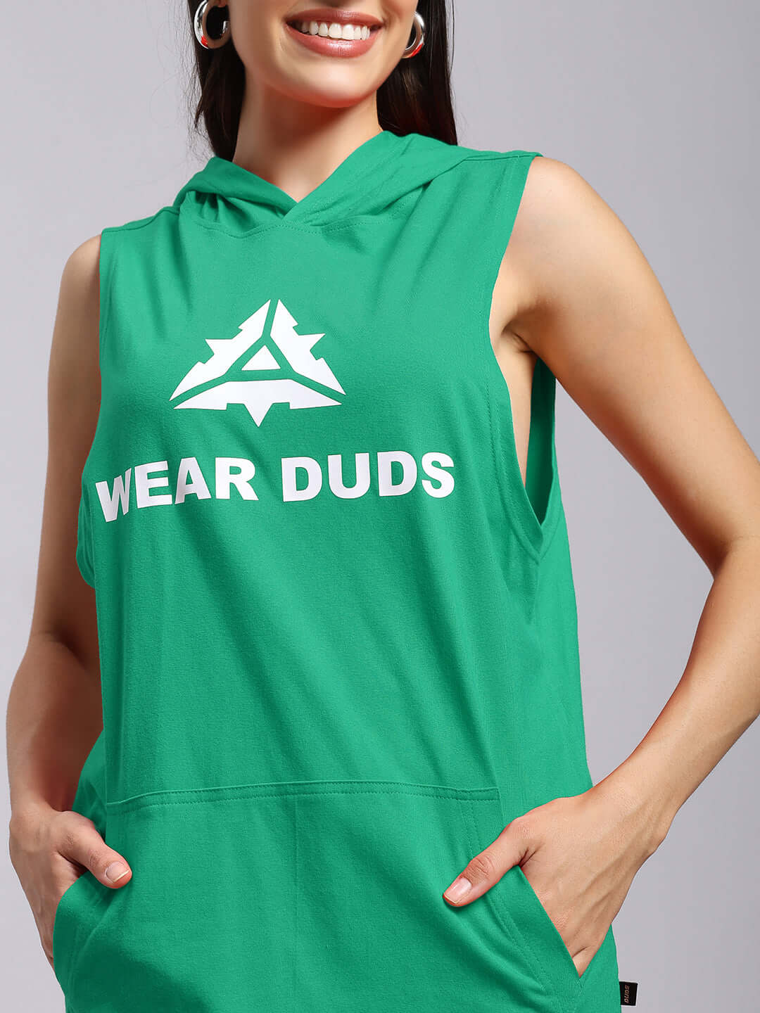 Woman wearing the vibrant green WOMENS CYBRAN GYM HOODED T-SHIRT GREEN with logo, designed for active wear and moisture-wicking performance.