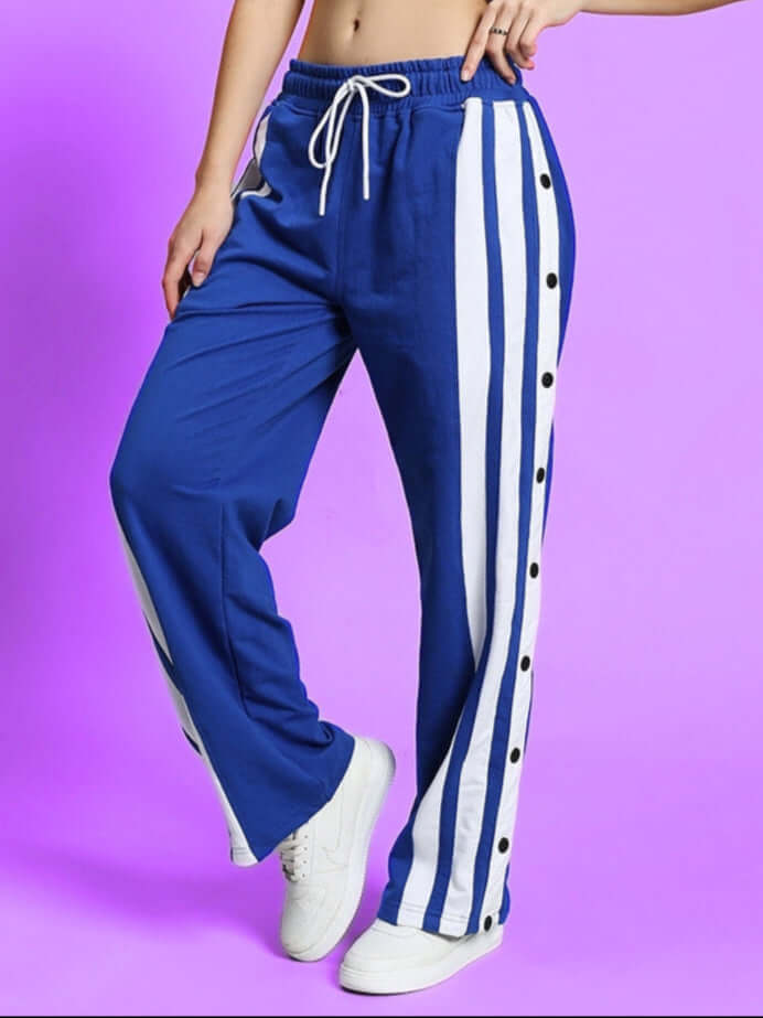 Women's royal blue-white dancer joggers with side stripes and drawstring waistband, displayed in a studio setting.