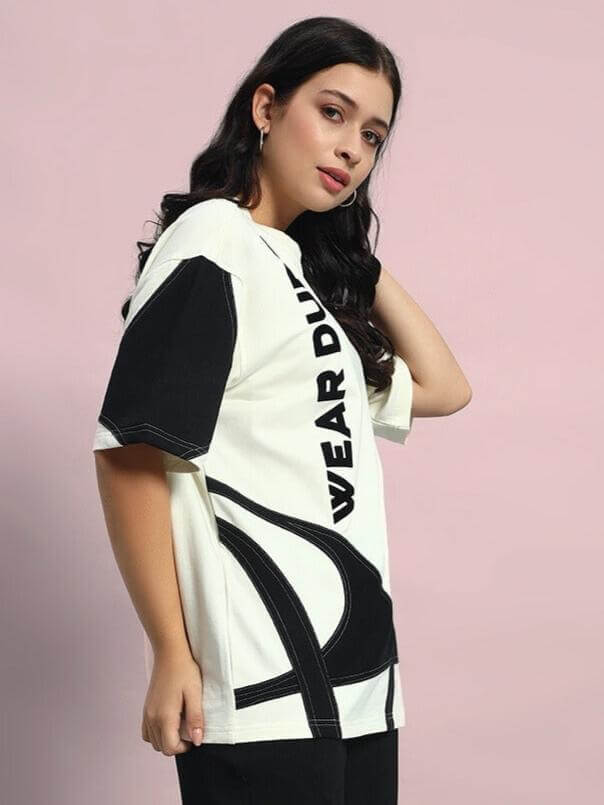 Model wearing Women's David Designer Oversized T-Shirt in off white and black, showcasing bold graphic design and comfortable fit.