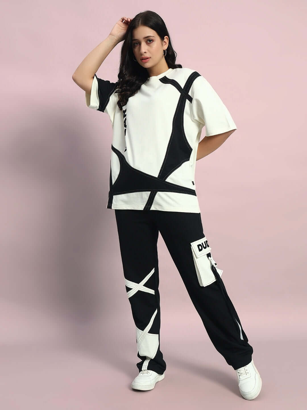 Woman wearing oversized co-ord set in off-white and black with relaxed fit joggers and drawstring waistband, stylish fashion outfit.