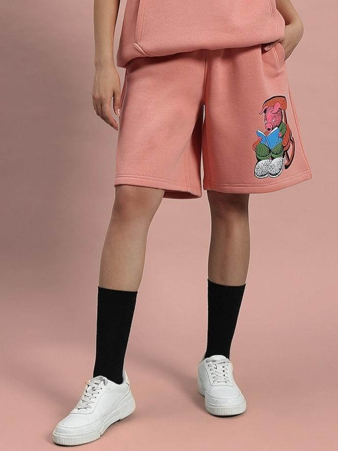Woman wearing WOMEN DELIBERATE FLEECE SHORTS PEACH, styled with black socks and white sneakers for a comfortable, casual look