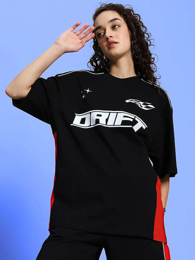 Model wearing women's black oversized drift t-shirt with red accents, showcasing a casual and trendy style.