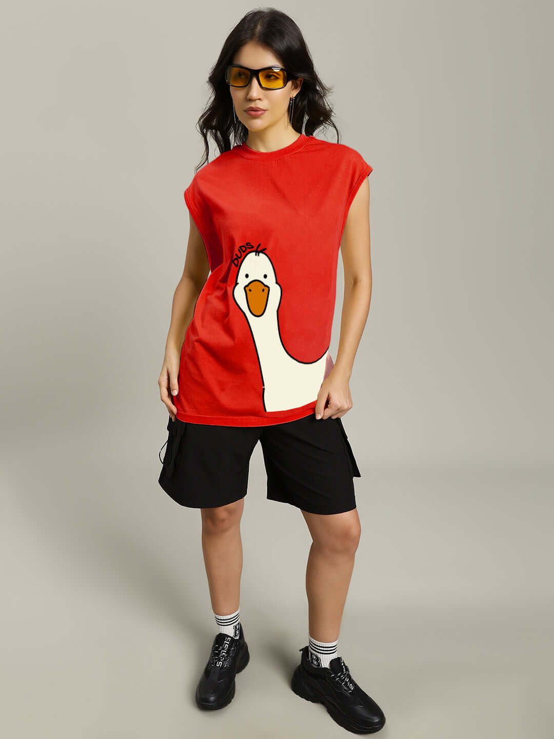 Model wearing Women's Duck Look Gym T-Shirt in red, featuring a duck graphic, paired with black shorts and shoes.