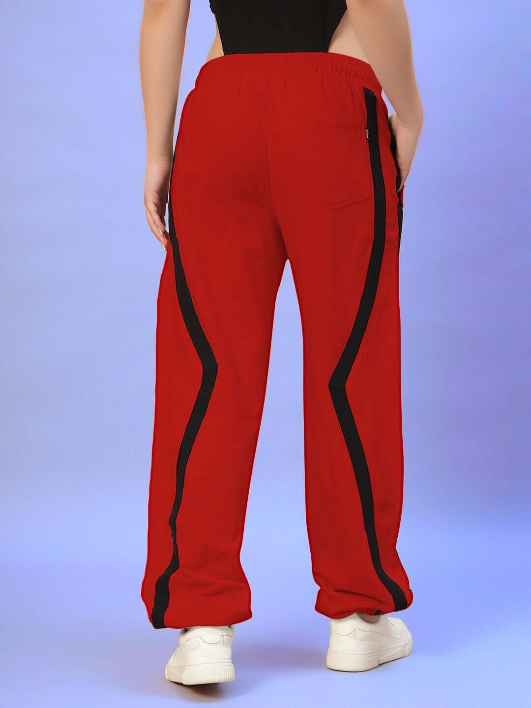 Rear view of a person wearing red Women's DUDS Frame Joggers with black stripes, showcasing stylish and comfortable fit.