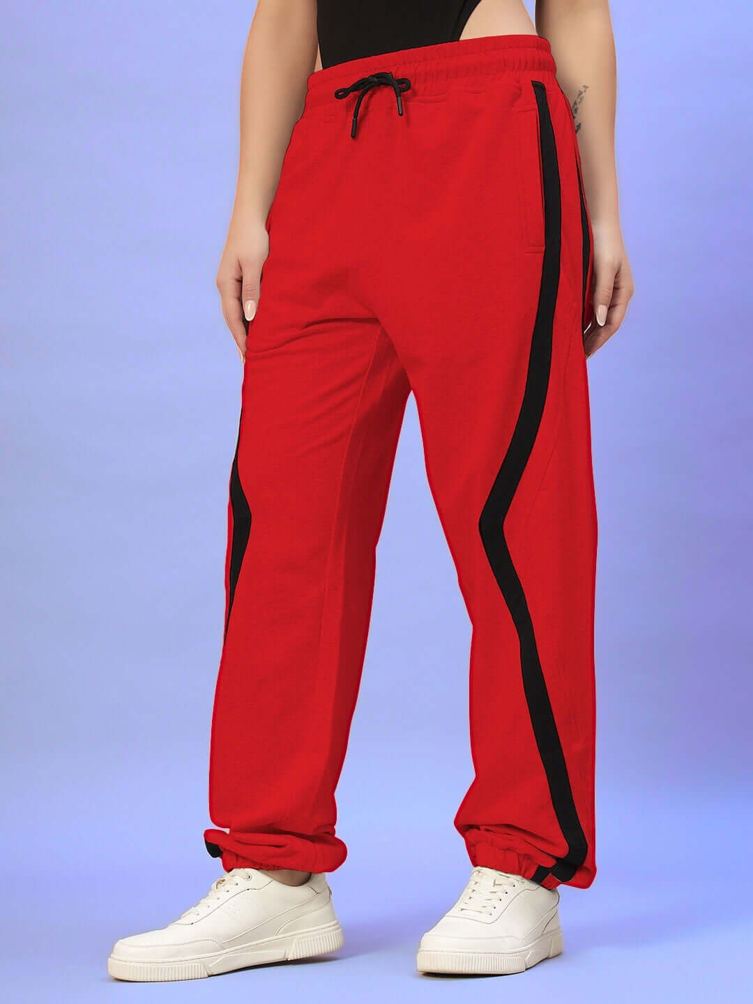Women's red joggers by DUDS with black stripe detail, custom fit option available, made to order by skilled tailors.