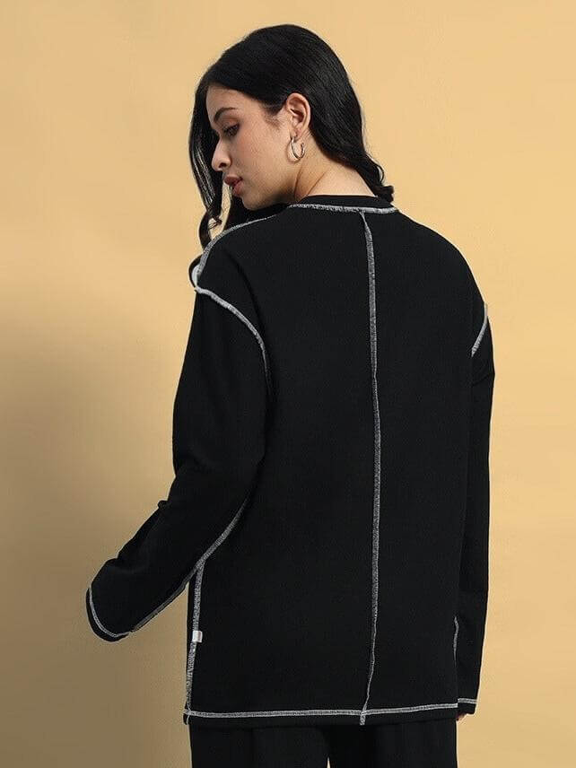 Back view of a model wearing Women's Dynamic Oversized Sweatshirt Black, showcasing its stylish and comfortable design.