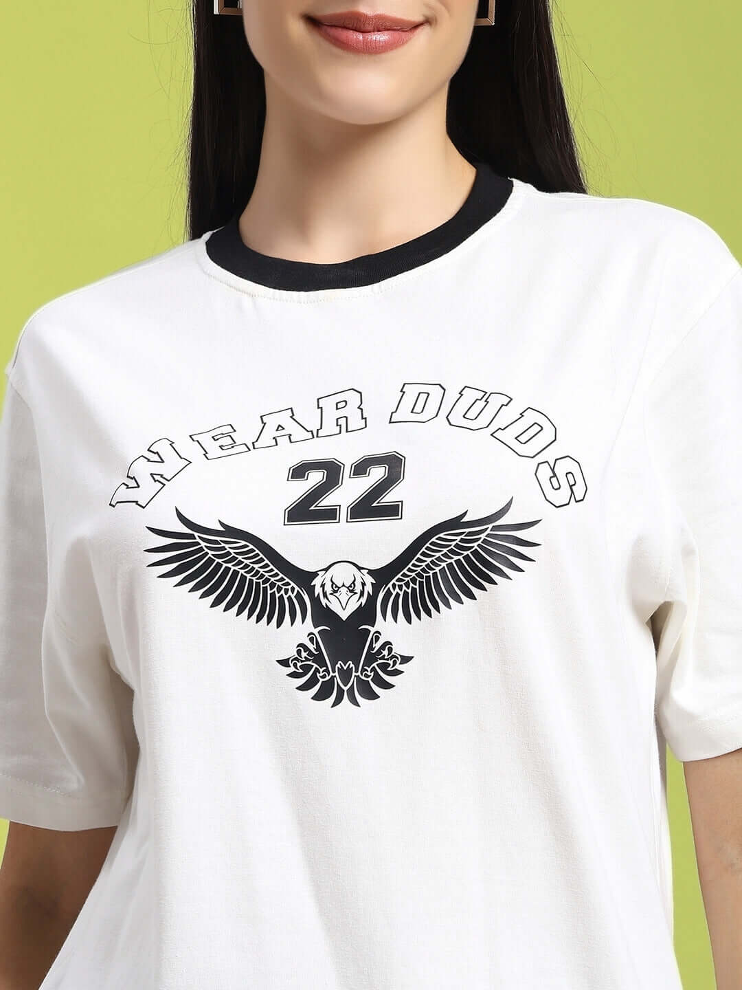 Woman wearing a white Women's Eagle Wings regular fit t-shirt with 'Wear Duds 22' print, made of 100% cotton.