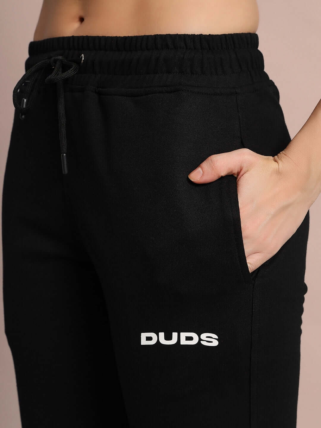 Close-up of Women's Eddie Contrast Black Joggers with pocket detail and DUDS logo, showcasing made-to-order craftsmanship.