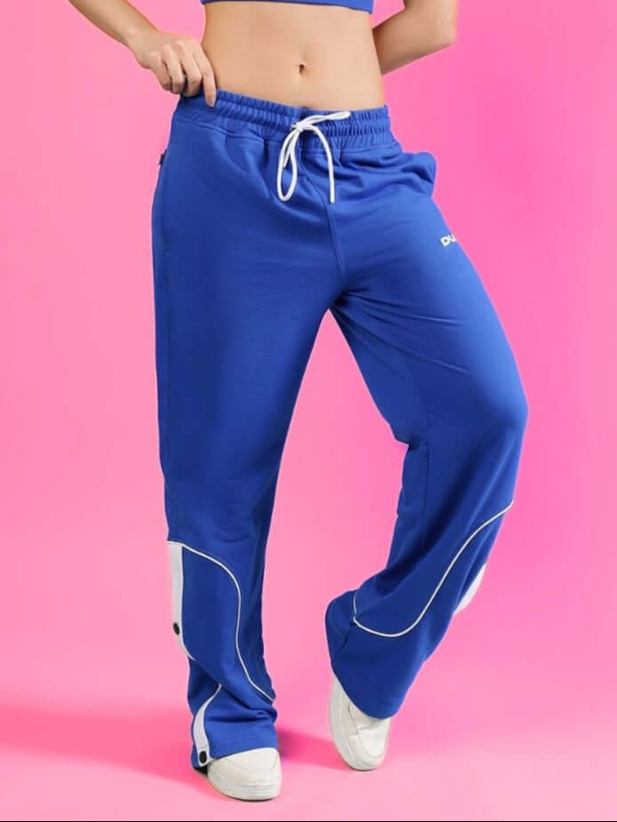 Women's Eddie Contrast Joggers in Blue with white drawstring and accents, made by DUDS, shown on a pink background.