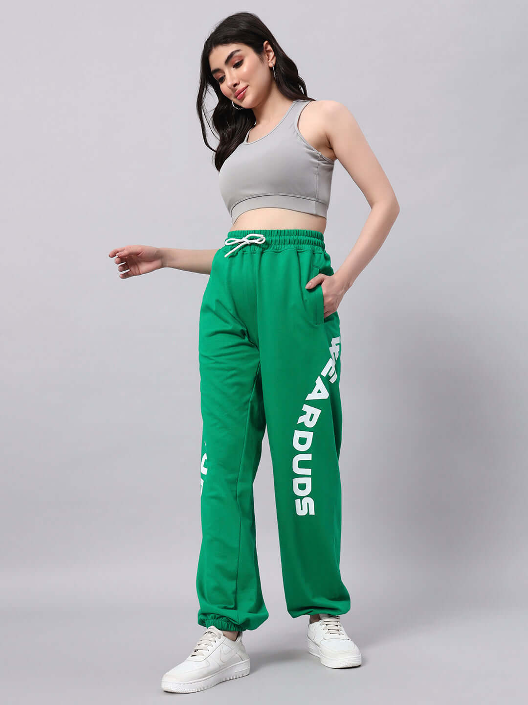 Model wearing WOMEN'S ELLEN RELAXED FIT JOGGER GREEN with side text 'DUDS'. Comfortable joggers for everyday wear.