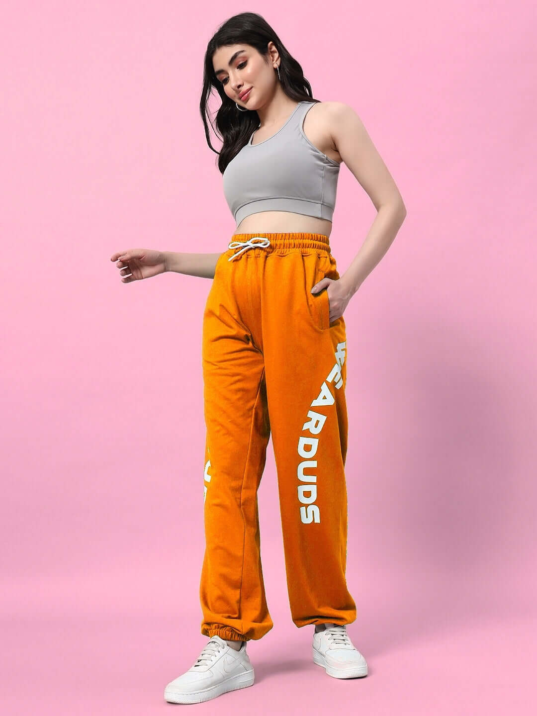 Model wearing WOMEN'S ELLEN RELAXED FIT JOGGER ORANGE, showcasing the bold color and comfortable design.
