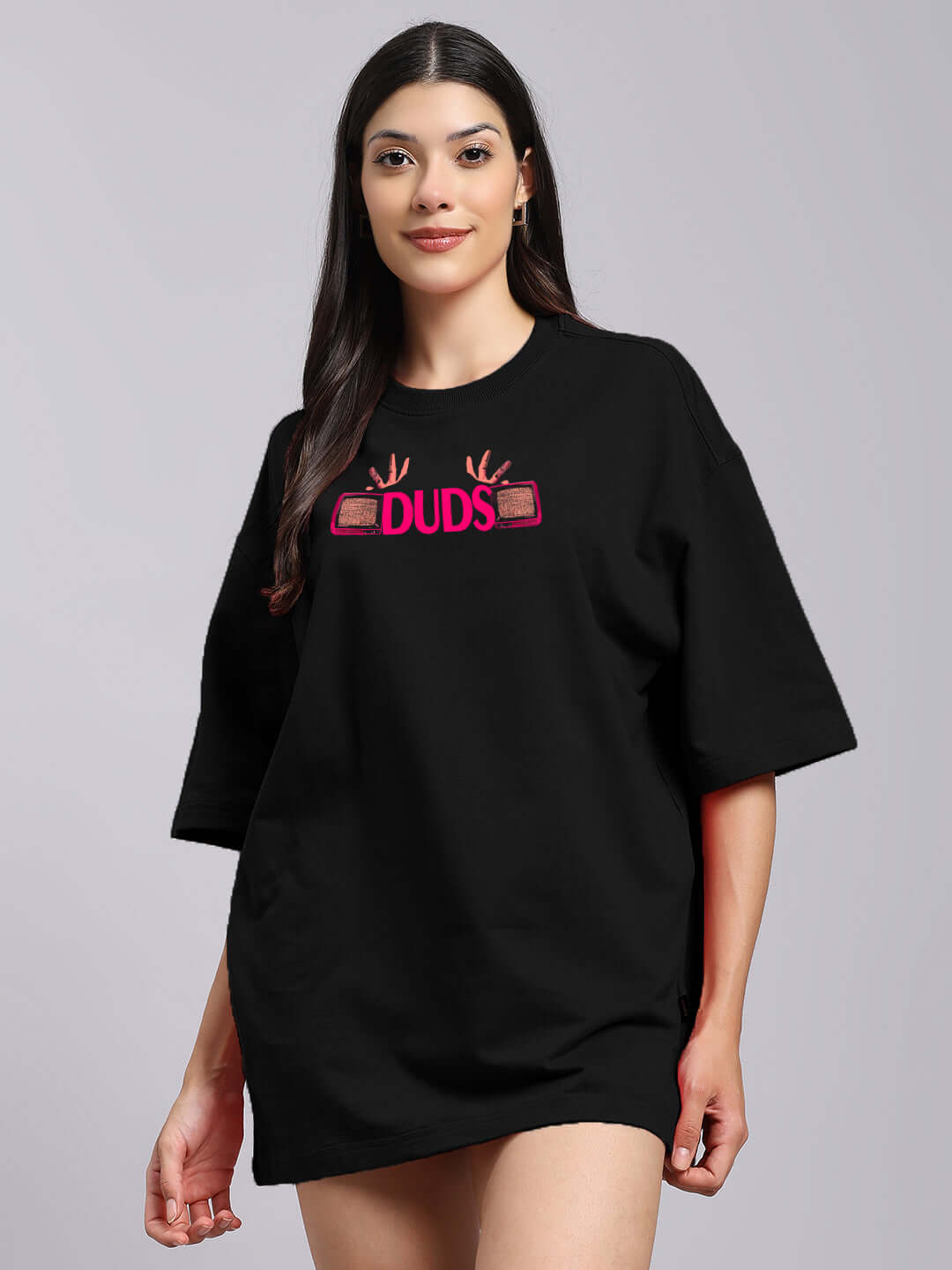 Woman wearing Eyeconic oversized black T-shirt with graphic print, made from premium cotton and elastane blend, 240 GSM, India.
