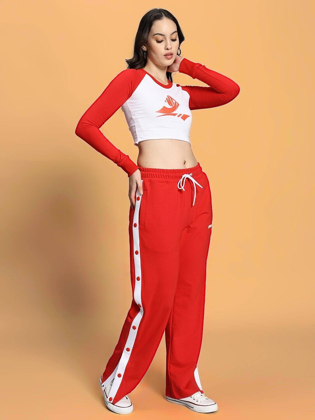 Model wearing WOMEN'S EZEL CO-ORD SET RED-WHITE, featuring sporty chic style with red top and white accents for modern energy and fashion.