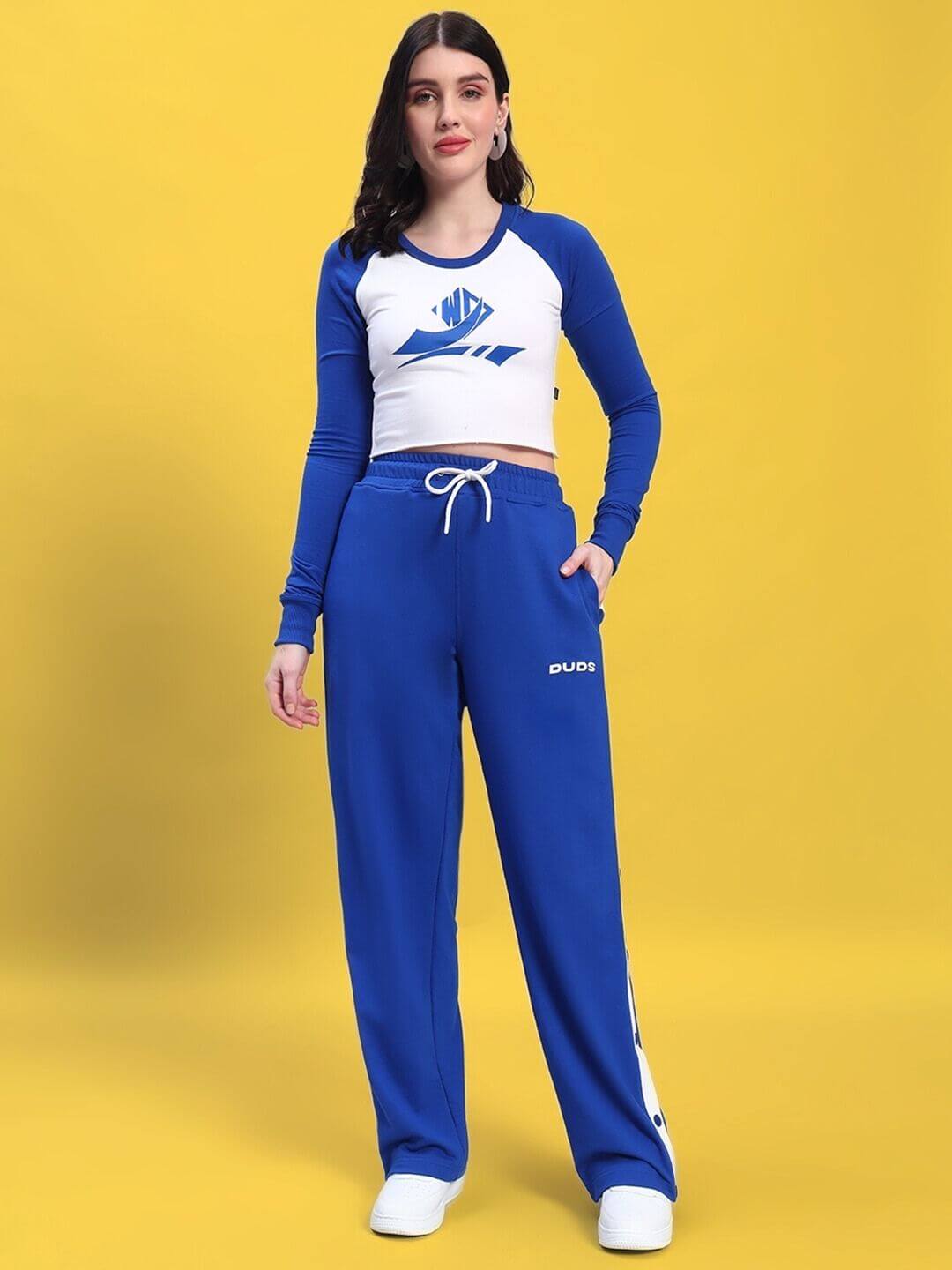 Woman wearing WOMEN'S EZEL CO-ORD SET ROYAL BLUE-WHITE with blue top and white bottoms, showcasing a chic and sporty look.