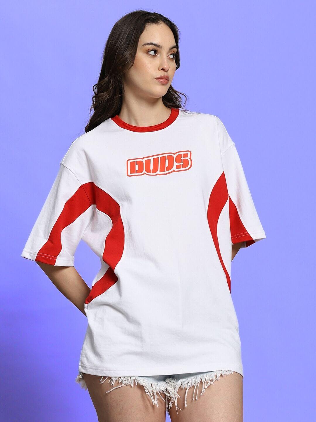 Woman wearing oversized white-red Women's Ezel T-shirt, featuring bold red logo and accents, made of premium cotton blend fabric.