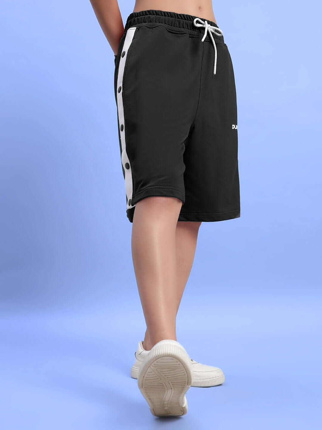 Women's Ezel regular fit black shorts with side button accents, displayed on model, highlighting comfortable and stylish design.