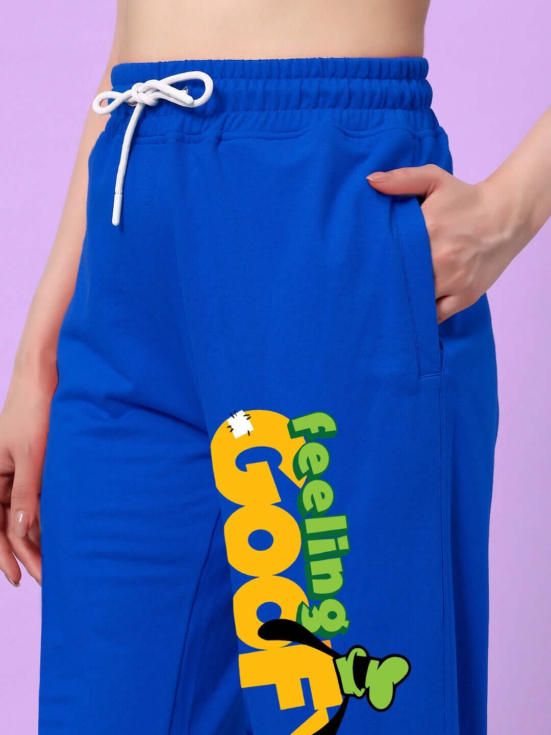 Woman wearing WOMEN'S FEELING GOOFY RELAXED FIT JOGGER BLUE with playful design and side print.