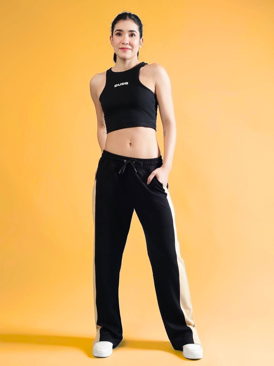 Model wearing WOMEN'S FITFINITY CO-ORD SET BLACK with relaxed fit joggers and elasticated waistband.