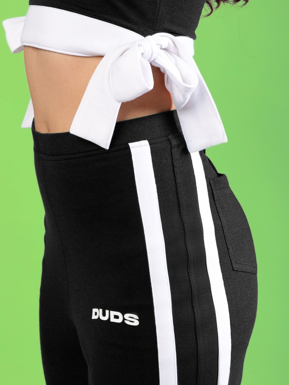WOMENS FITTONIA COOL WIDE FLARE JOGGERS BLACK on model showcasing side view and sporty design