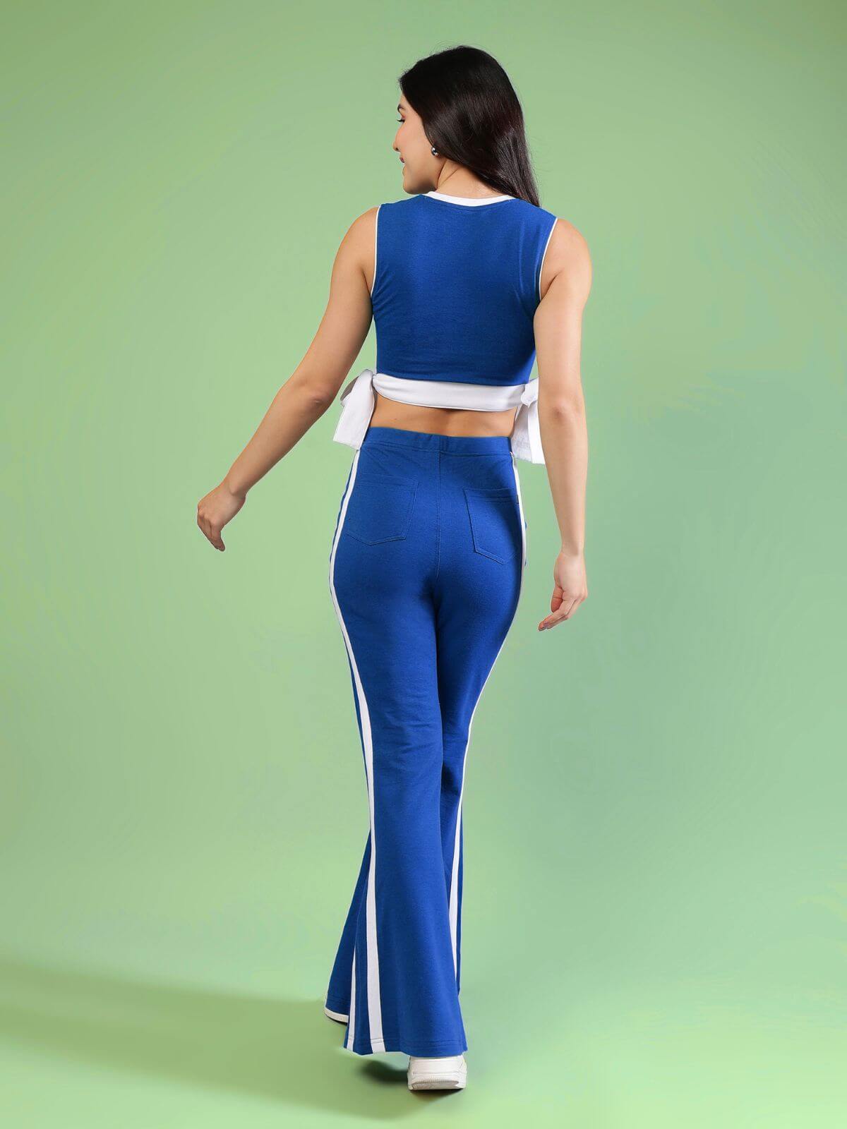 WOMENS FITTONIA COOL CO-ORD SET BLUE shows the back view of a stylish blue outfit with flared pants.