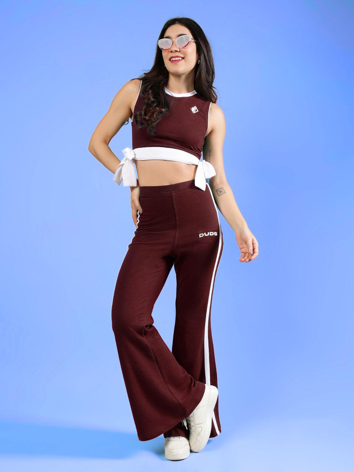WOMENS FITTONIA COOL CO-ORD SET MAROON displayed by a model against a blue background, showcasing its trendy style.