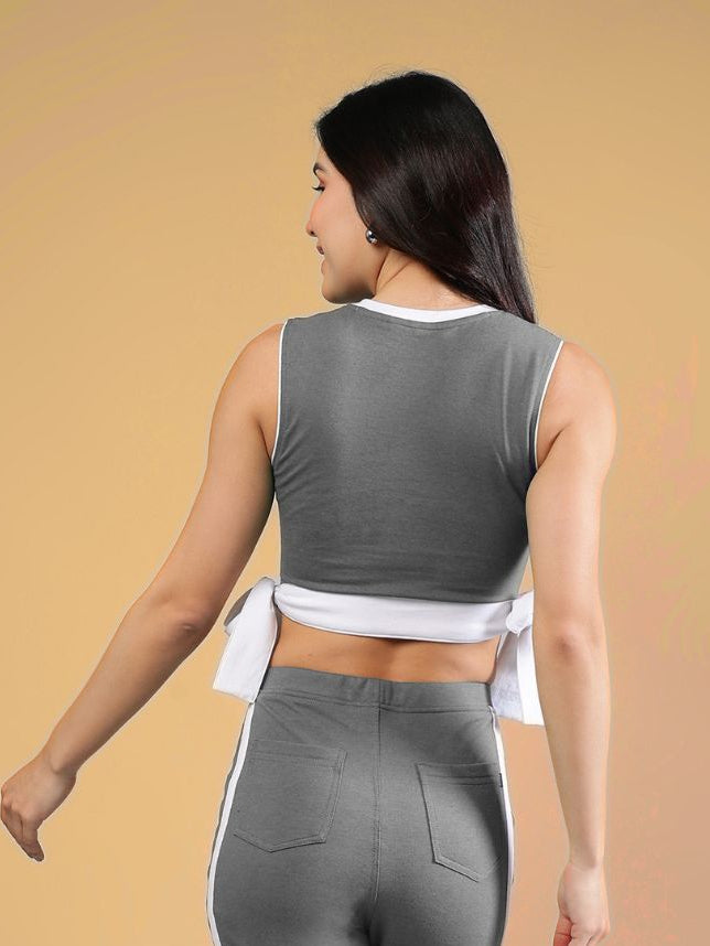 WOMENS FITTONIA COOL CROP TOP GREY worn by a model from the back, showcasing its trendy cropped design.