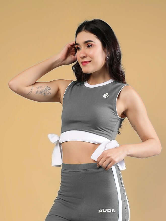 WOMENS FITTONIA COOL CROP TOP GREY worn by a model, showcasing the stylish cropped design and bow tie detail.