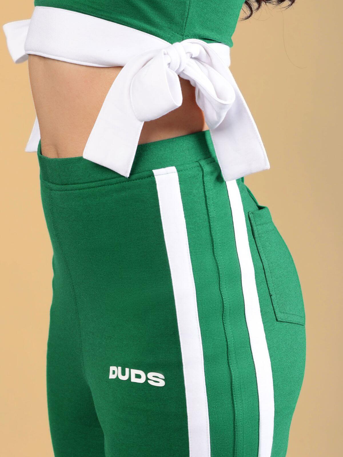 WOMENS FITTONIA COOL WIDE FLARE JOGGERS GREEN featuring a stylish design and comfortable fit in vibrant green.