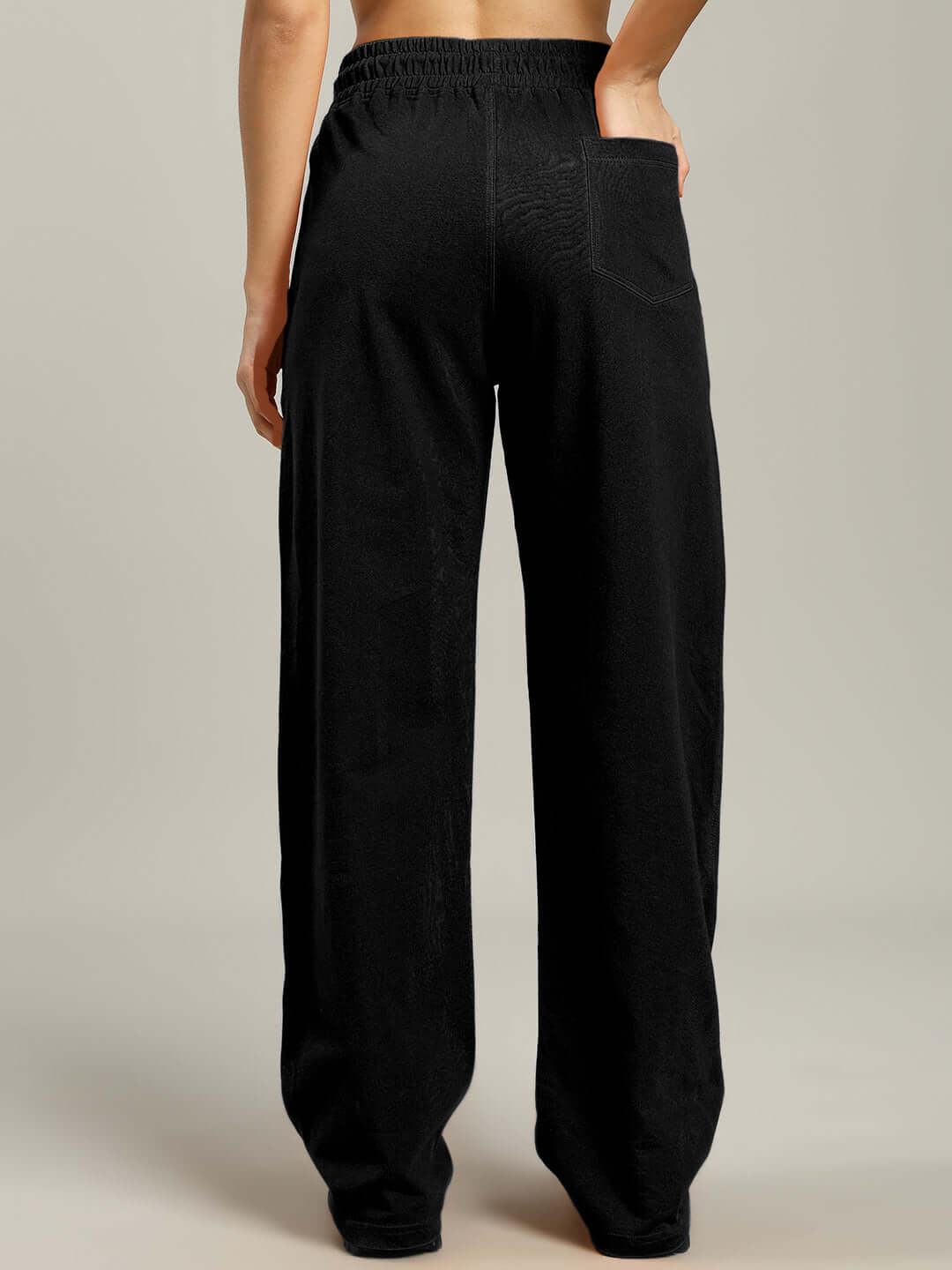 Back view of WOMENS FLAMING SKELETON PRINTED RELAXED FIT JOGGER BLACK showcasing its comfortable and edgy streetwear style.