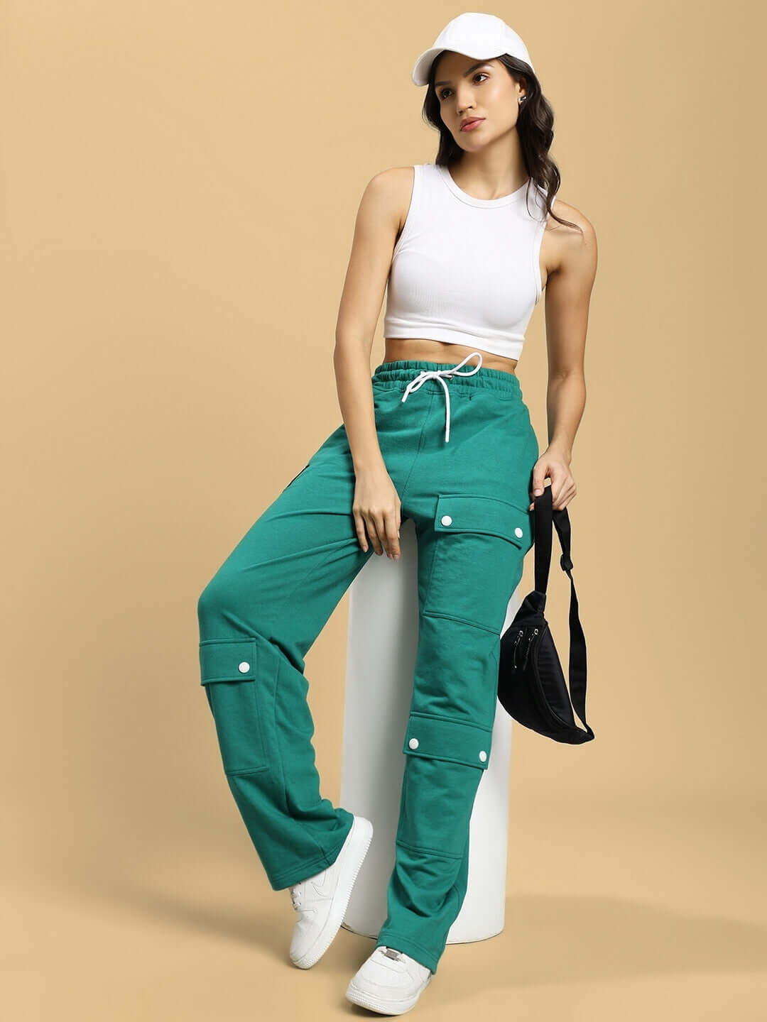 Model wearing WOMENS AWESOME FLAP POCKET BAGGY JOGGER GREEN showcasing streetwear style and comfort.