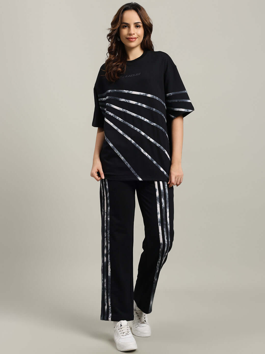 Woman wearing WOMEN'S FLICKER JOGGER COTTON TERRY BLACK outfit, comfortable made-to-order joggers and top.