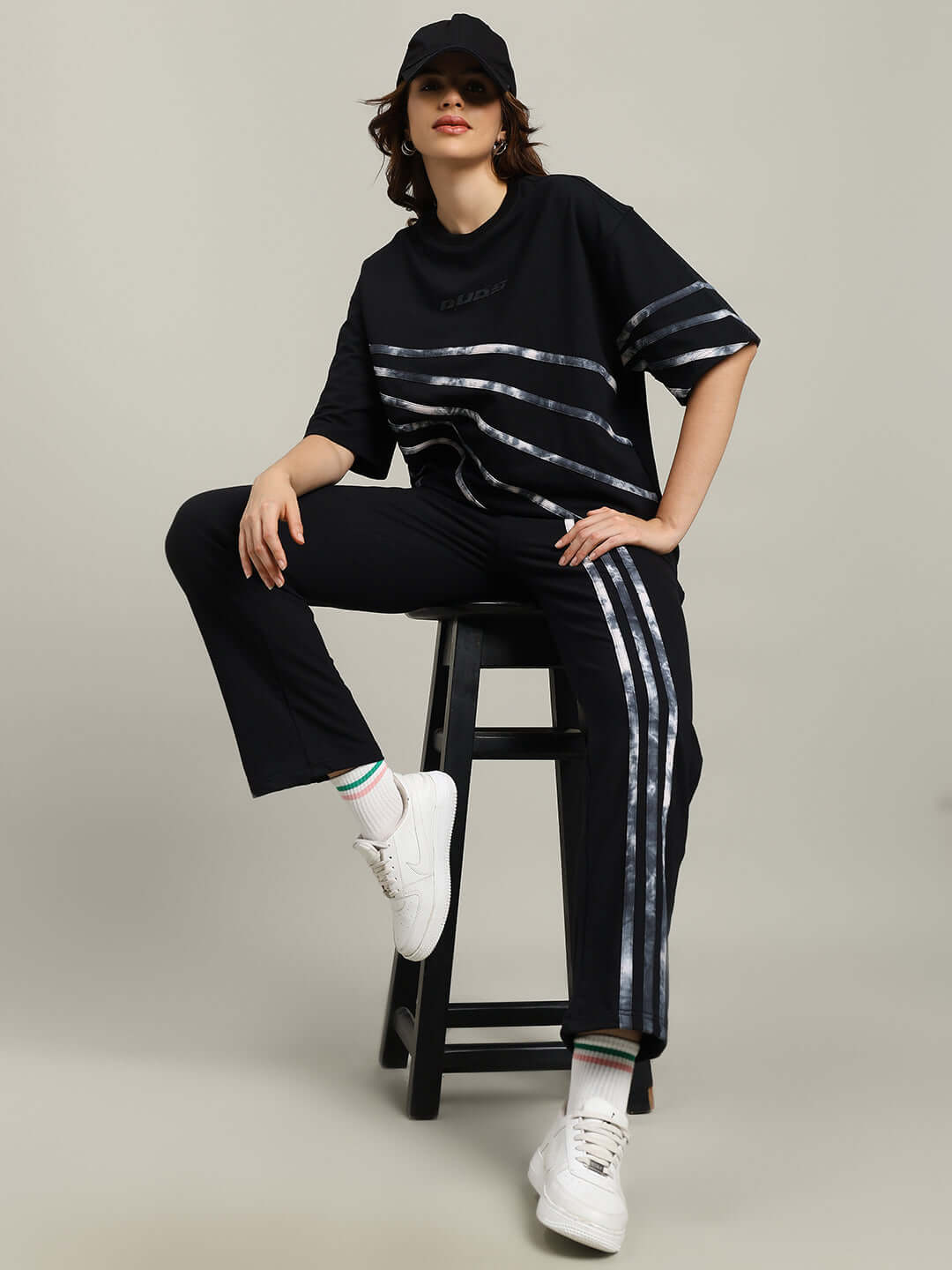 Model wearing WOMEN'S FLICKER OVERSIZED CO-ORD SET BLACK, featuring relaxed fit joggers and drawstring waistband.