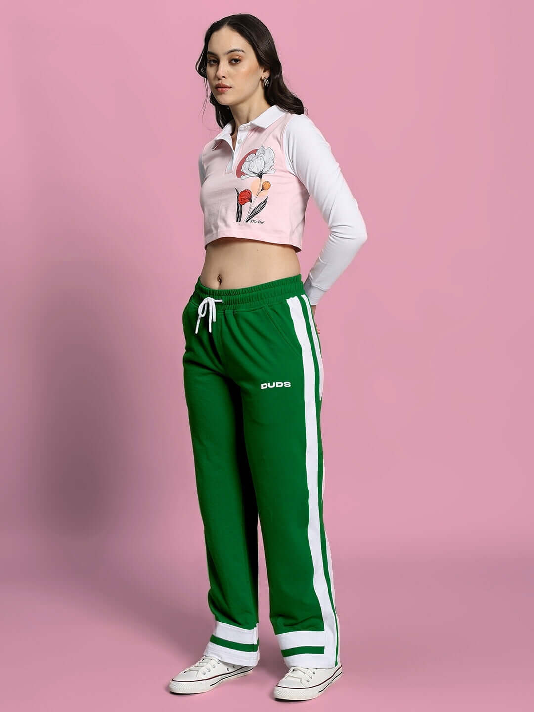 Model wearing WOMEN'S FLORA CO-ORD SET PINK GREEN by WEAR DUDS, featuring a pink top and green pants in a vibrant streetwear style.