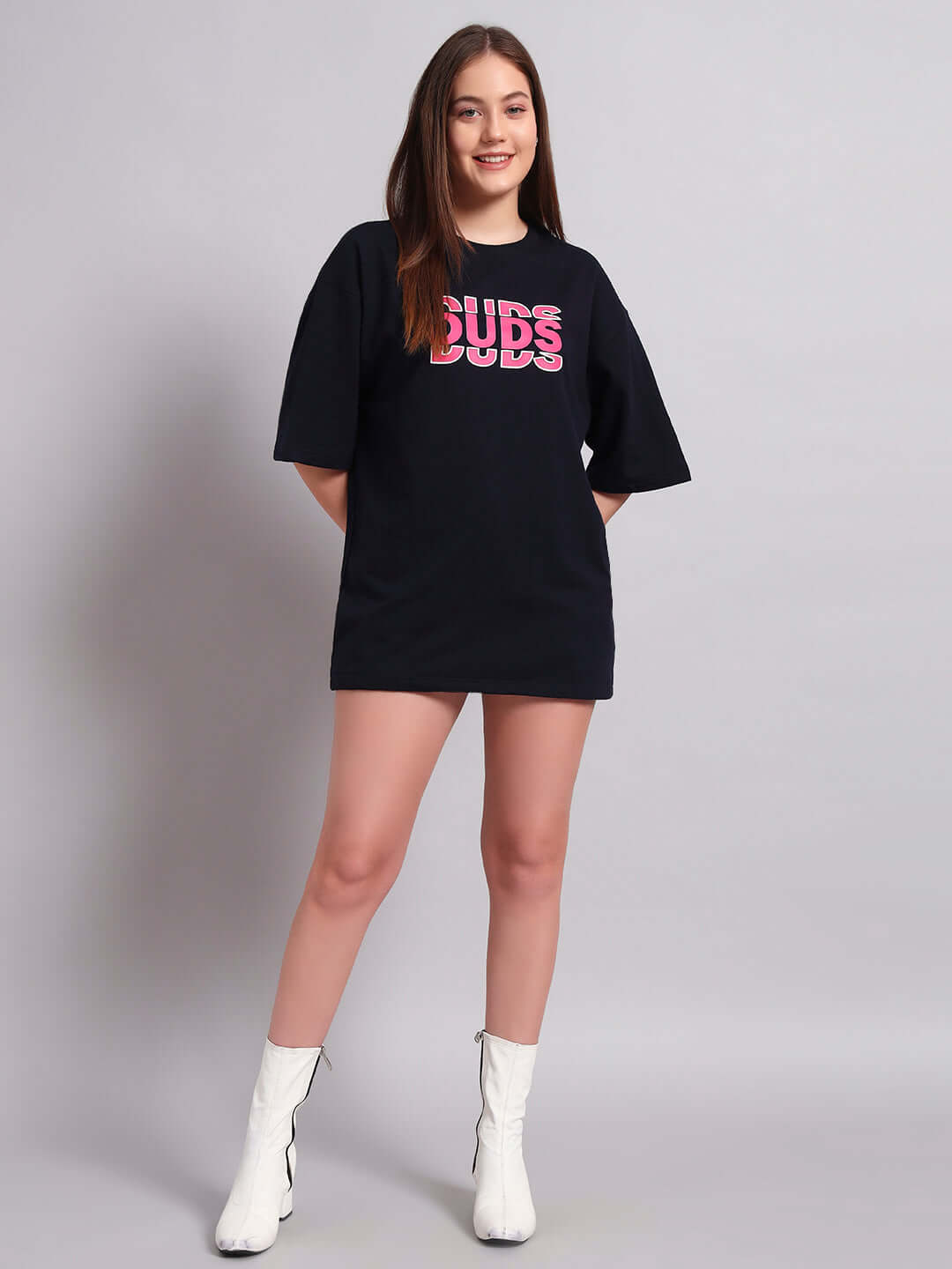 Women's navy blue oversized T-shirt with creative print, premium cotton blend, styled with white boots, ideal casual wear.