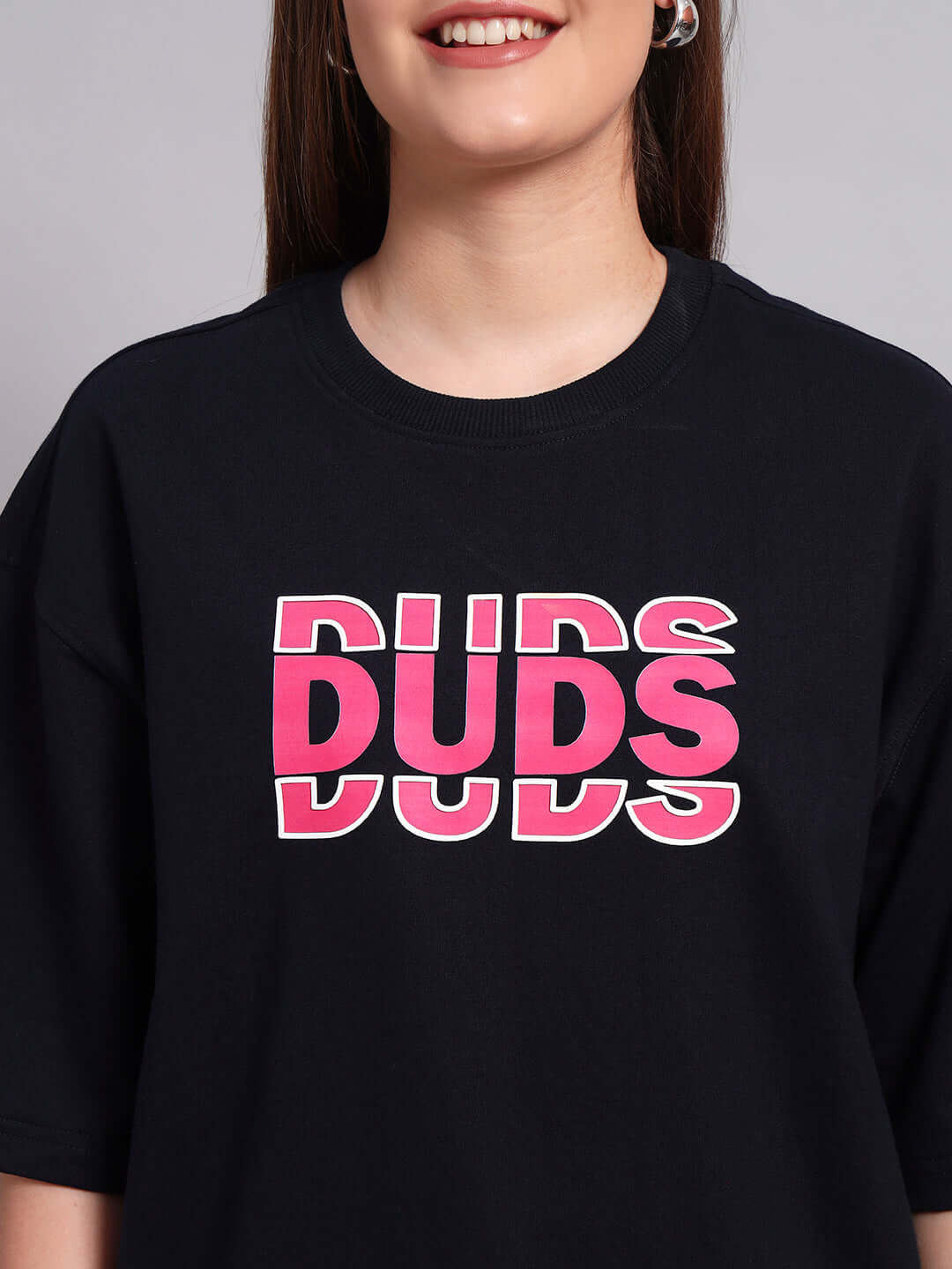 Navy blue oversized women's T-shirt with creative pink "DUDS" print, made from premium cotton fabric.