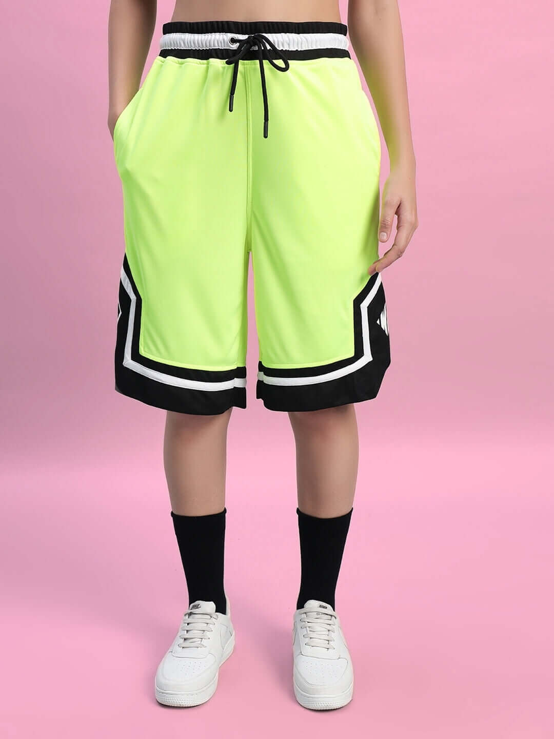 Front view of a person wearing the WOMEN'S FRANKY GYM CO-ORD SET NEON GREEN, showcasing sporty shorts with a vibrant, stylish design.
